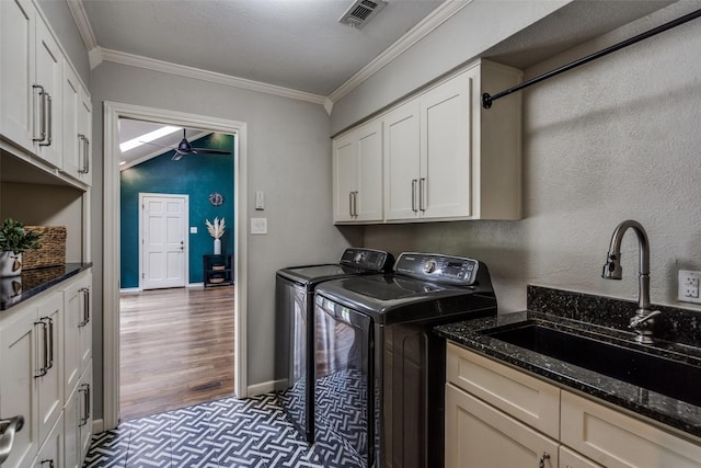 2021 Wing Point Ln, Plano, TX 75093 - laundry area featuring separate washer and dryer, crown molding, cabinet space, a ceiling fan, and wood finished floors