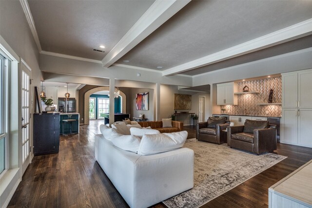 2021 Wing Point Ln, Plano, TX 75093 - living area featuring arched walkways, beamed ceiling, ornamental molding, dark wood-style flooring, and ornate columns