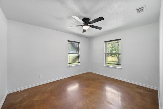 604 Donna Cir, Kerens, TX 75144 - empty room with finished concrete floors, ceiling fan, and a textured ceiling