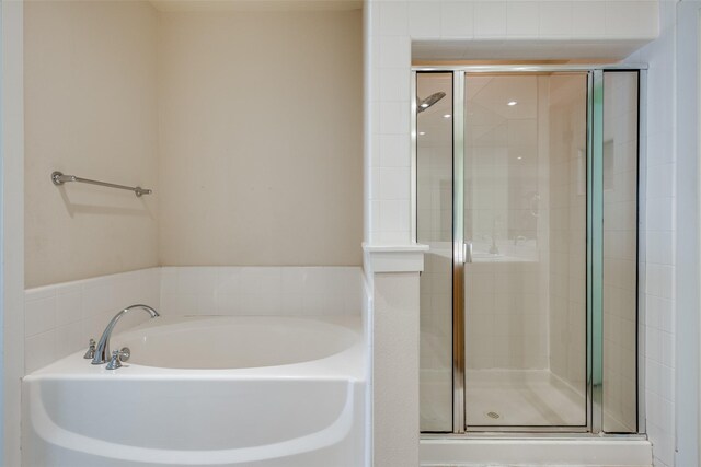 4830 Cedar Springs Rd Unit 12, Dallas, TX 75219 - bathroom with a garden tub and a shower stall