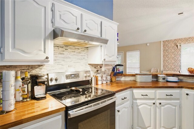 111 Christopher Dr, Cooper, TX 75432 - kitchen featuring butcher block countertops, stainless steel electric stove, under cabinet range hood, and white cabinets