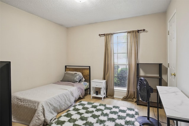 111 Christopher Dr, Cooper, TX 75432 - bedroom with wood finished floors, multiple windows, and a textured ceiling