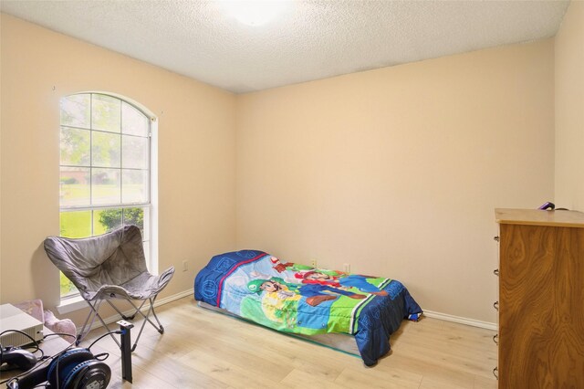 111 Christopher Dr, Cooper, TX 75432 - bedroom with wood finished floors, baseboards, and a textured ceiling