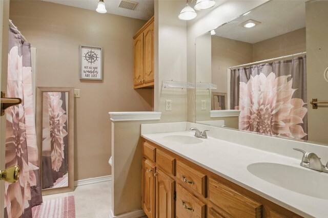 111 Christopher Dr, Cooper, TX 75432 - full bathroom with double vanity, tile patterned flooring, baseboards, and a shower with shower curtain