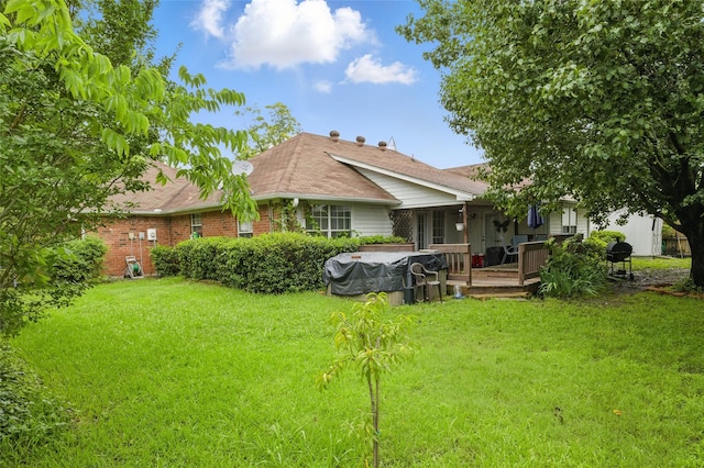 111 Christopher Dr, Cooper, TX 75432 - rear view of house with a lawn, a wooden deck, and brick siding