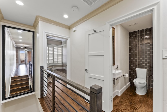 5055 Addison Cir Unit 723, Addison, TX 75001 - bathroom featuring toilet, ornamental molding, wood finished floors, recessed lighting, and baseboards