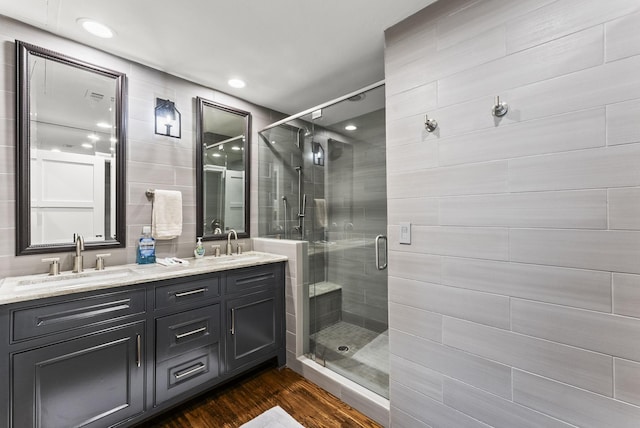 5055 Addison Cir Unit 723, Addison, TX 75001 - full bathroom with double vanity, a shower stall, and wood finished floors