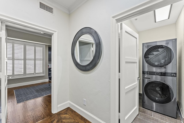 5055 Addison Cir Unit 723, Addison, TX 75001 - laundry room with stacked washer / dryer, crown molding, baseboards, and dark wood-type flooring