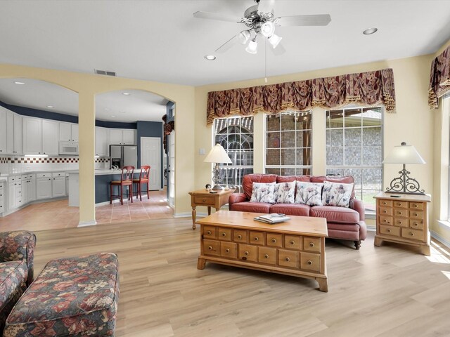 2832 Lincolnshire Dr, Richardson, TX 75082 - living area with arched walkways, light wood-style flooring, ceiling fan, and recessed lighting