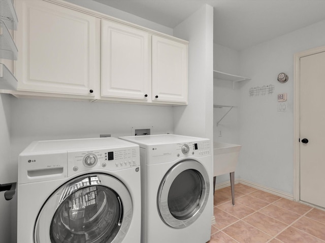 2832 Lincolnshire Dr, Richardson, TX 75082 - laundry room featuring washing machine and dryer, cabinet space, light tile patterned flooring, and baseboards