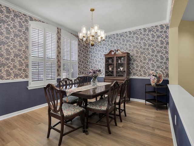 2832 Lincolnshire Dr, Richardson, TX 75082 - dining space featuring wainscoting, wallpapered walls, a chandelier, crown molding, and wood finished floors