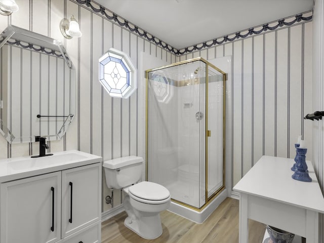 2832 Lincolnshire Dr, Richardson, TX 75082 - full bathroom featuring wallpapered walls, wood finished floors, toilet, a shower stall, and vanity