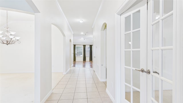 1424 Charleston Dr, Allen, TX 75002 - hall with arched walkways, crown molding, a chandelier, light tile patterned floors, and baseboards