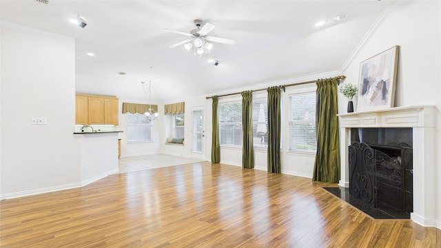 1424 Charleston Dr, Allen, TX 75002 - unfurnished living room with a ceiling fan, ornamental molding, light wood-style floors, a tiled fireplace, and recessed lighting