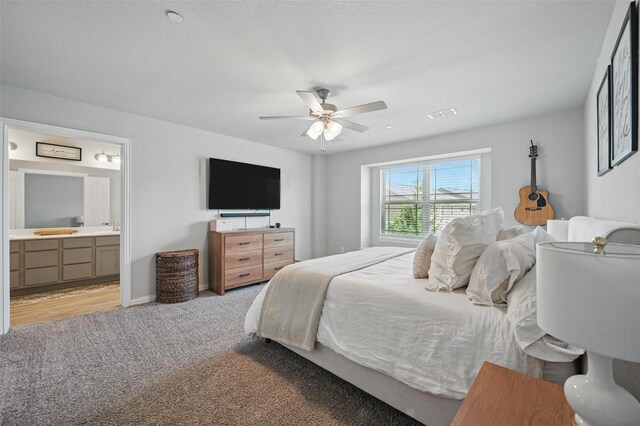 2409 Davenport Dr, Denton, TX 76207 - bedroom featuring light carpet, a sink, connected bathroom, a ceiling fan, and baseboards