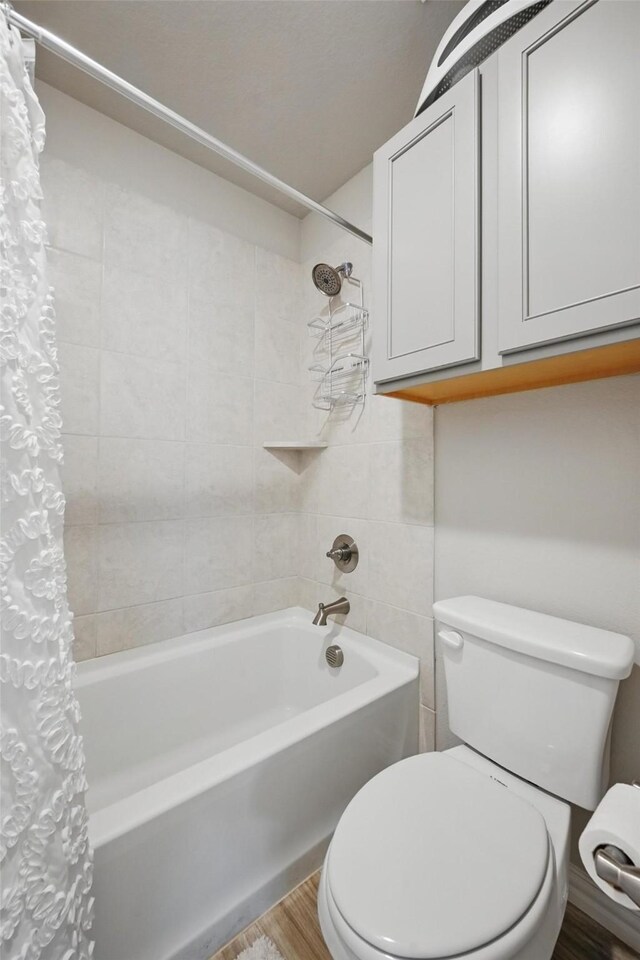 2409 Davenport Dr, Denton, TX 76207 - full bath featuring toilet, shower / bath combo, and wood finished floors