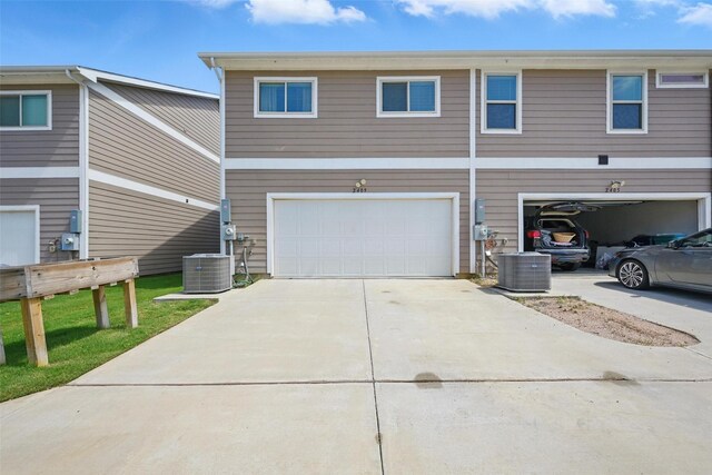2409 Davenport Dr, Denton, TX 76207 - view of front of house with an attached garage, central AC unit, and driveway