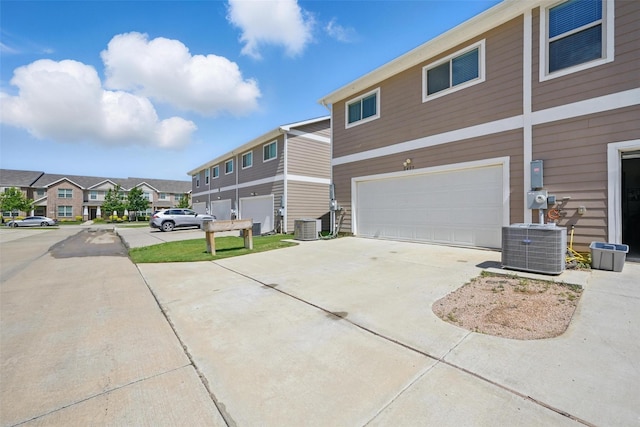 2409 Davenport Dr, Denton, TX 76207 - view of property exterior featuring central AC, concrete driveway, an attached garage, and a residential view