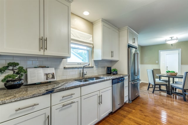 13841 Far Hills Ln, Dallas, TX 75240 - kitchen featuring stainless steel appliances, white cabinets, and tasteful backsplash