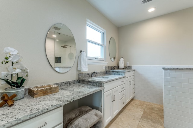 13841 Far Hills Ln, Dallas, TX 75240 - bathroom featuring vanity, tile walls, a shower, a wainscoted wall, and tile patterned floors