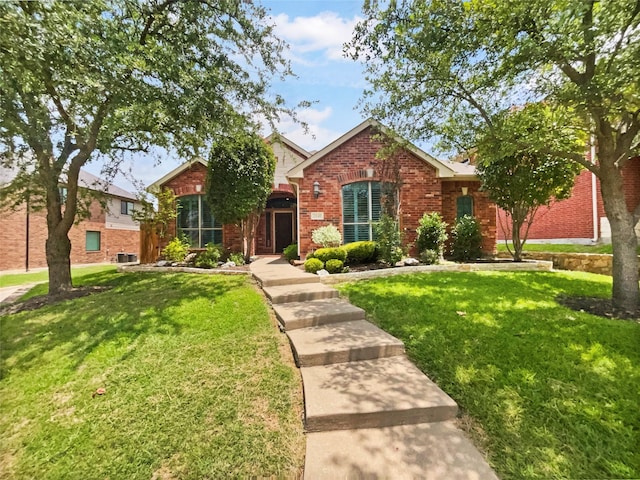 2140 Heather Glen Dr, Rockwall, TX 75087 - traditional-style home featuring brick siding, a front lawn, and central AC