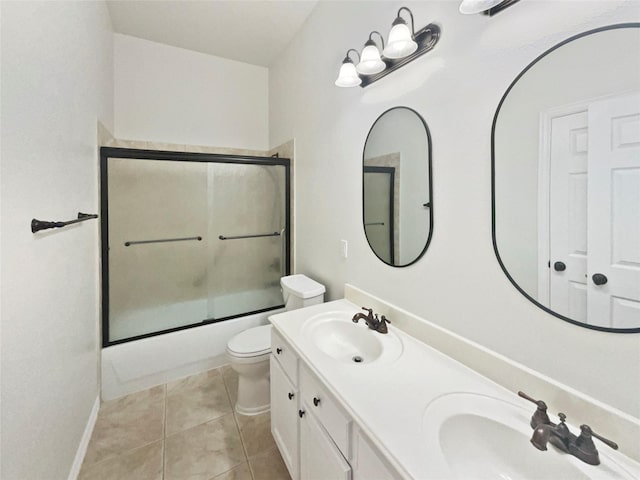 2140 Heather Glen Dr, Rockwall, TX 75087 - full bath featuring toilet, shower / bath combination with glass door, double vanity, tile patterned floors, and baseboards