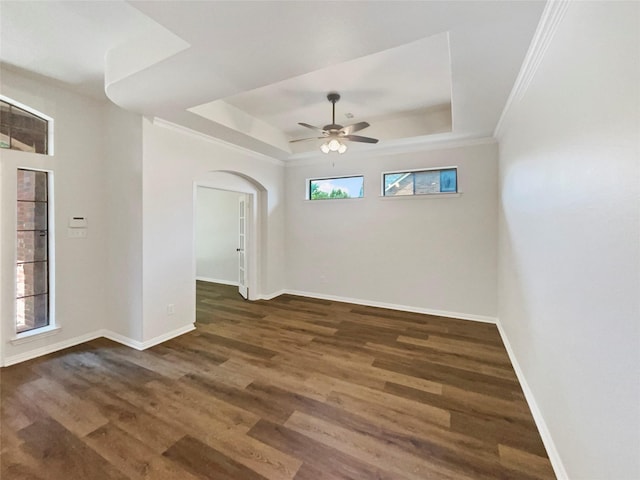 2140 Heather Glen Dr, Rockwall, TX 75087 - unfurnished room featuring a raised ceiling, arched walkways, ceiling fan, wood finished floors, and baseboards
