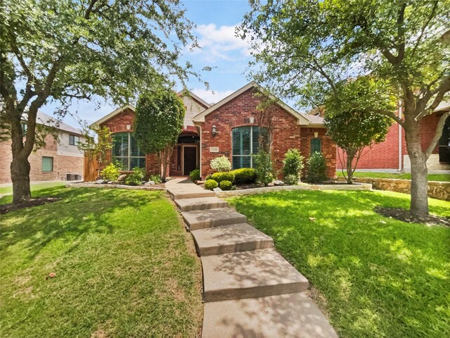 2140 Heather Glen Dr, Rockwall, TX 75087 - traditional-style house featuring brick siding and a front lawn