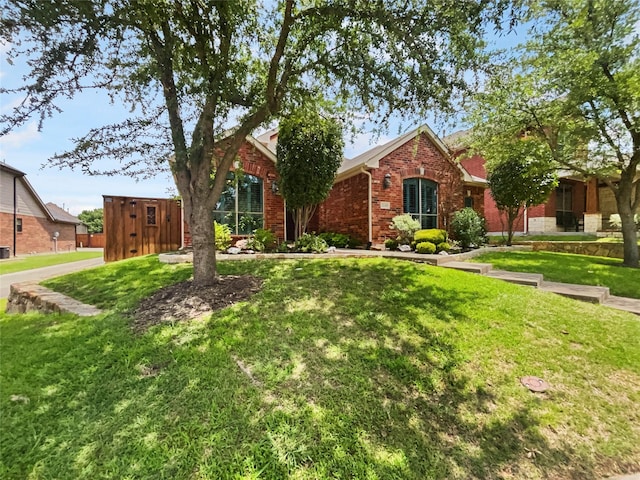 2140 Heather Glen Dr, Rockwall, TX 75087 - view of front of home with brick siding and a front lawn