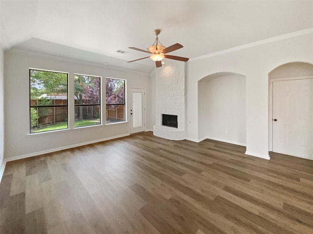2140 Heather Glen Dr, Rockwall, TX 75087 - unfurnished living room featuring wood finished floors, a ceiling fan, a stone fireplace, ornamental molding, and arched walkways