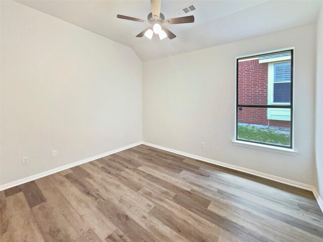 2140 Heather Glen Dr, Rockwall, TX 75087 - spare room featuring baseboards, wood finished floors, ceiling fan, and vaulted ceiling