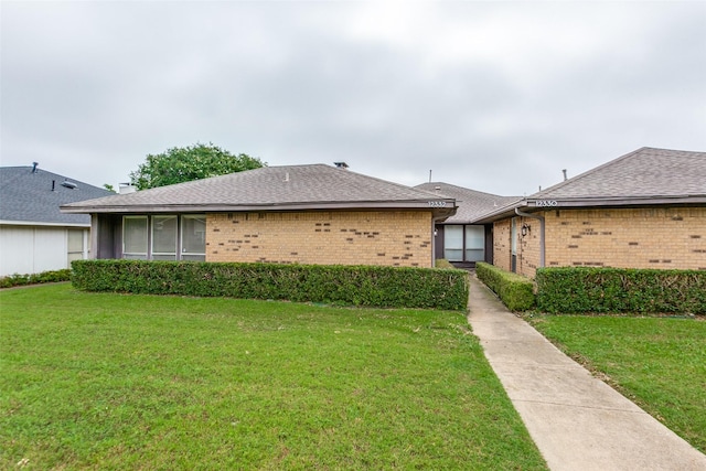12332 Ferris Creek Ln, Dallas, TX 75243 - single story home with brick siding, a front yard, and roof with shingles