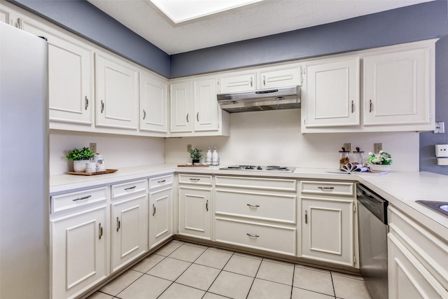 12332 Ferris Creek Ln, Dallas, TX 75243 - kitchen with under cabinet range hood, appliances with stainless steel finishes, light tile patterned flooring, light countertops, and white cabinets