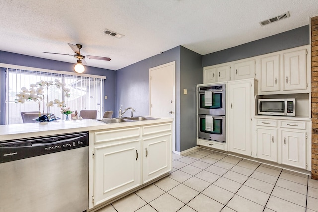 12332 Ferris Creek Ln, Dallas, TX 75243 - kitchen with appliances with stainless steel finishes, a sink, ceiling fan, a textured ceiling, and white cabinetry