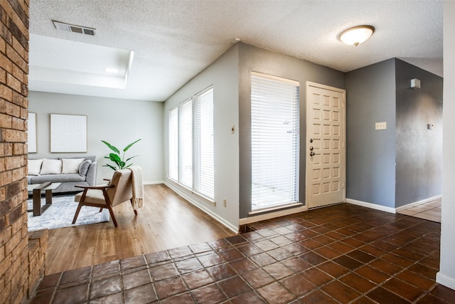 12332 Ferris Creek Ln, Dallas, TX 75243 - entrance foyer with a textured ceiling and baseboards