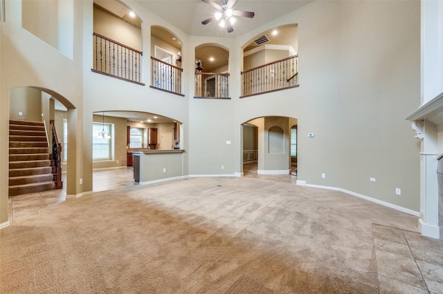 3500 Corkwood Dr, Frisco, TX 75033 - unfurnished living room with ceiling fan, light carpet, a high ceiling, baseboards, and stairway