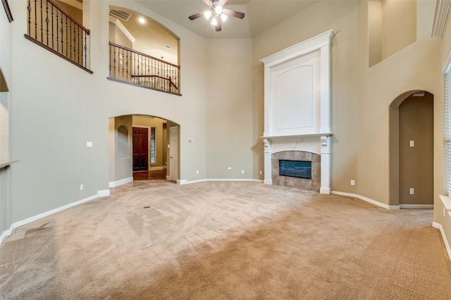 3500 Corkwood Dr, Frisco, TX 75033 - unfurnished living room featuring a ceiling fan, light carpet, arched walkways, baseboards, and a high ceiling