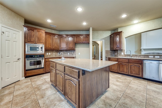 3500 Corkwood Dr, Frisco, TX 75033 - kitchen featuring appliances with stainless steel finishes, a sink, decorative backsplash, light tile patterned floors, and recessed lighting