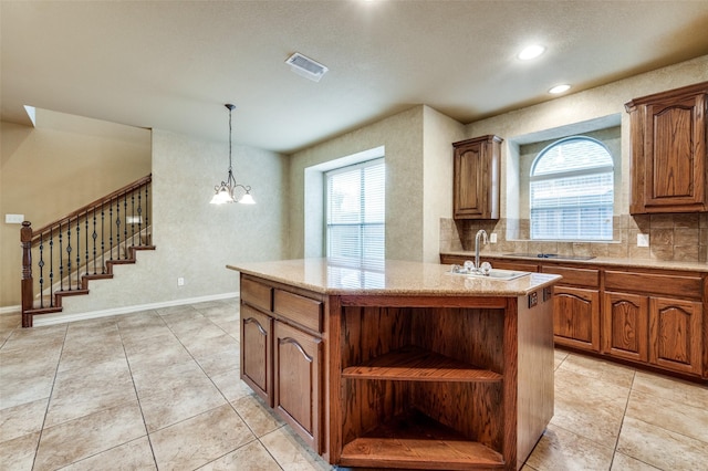 3500 Corkwood Dr, Frisco, TX 75033 - kitchen with a kitchen island with sink, a sink, open shelves, healthy amount of natural light, and recessed lighting