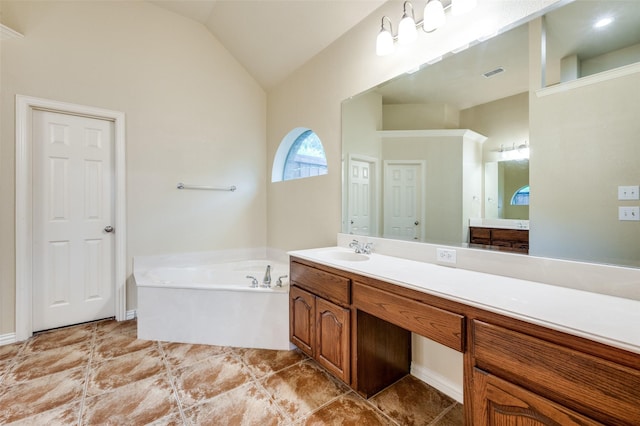 3500 Corkwood Dr, Frisco, TX 75033 - bathroom featuring a bath, vanity, tile patterned floors, and vaulted ceiling