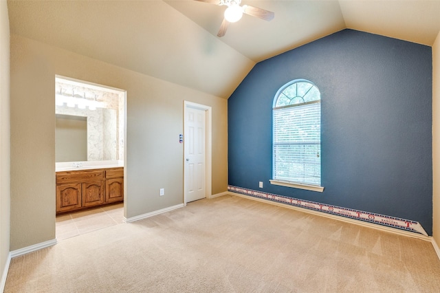 3500 Corkwood Dr, Frisco, TX 75033 - unfurnished bedroom with vaulted ceiling, light carpet, connected bathroom, a ceiling fan, and baseboards