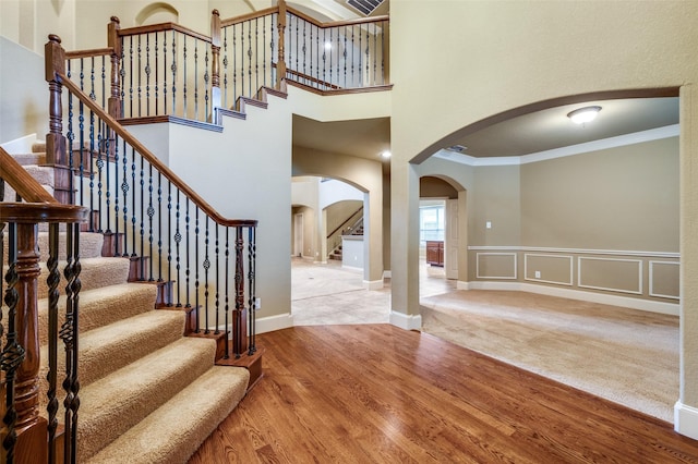 3500 Corkwood Dr, Frisco, TX 75033 - entryway with arched walkways, stairs, crown molding, wood finished floors, and baseboards