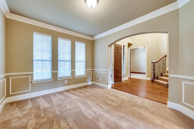 3500 Corkwood Dr, Frisco, TX 75033 - spare room featuring carpet flooring, arched walkways, ornamental molding, and stairway