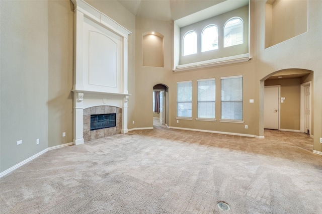 3500 Corkwood Dr, Frisco, TX 75033 - unfurnished living room with a towering ceiling, carpet, baseboards, and arched walkways