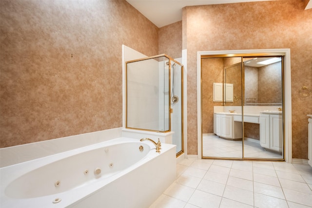 8635 Forest Glen Dr, Irving, TX 75063 - bathroom featuring a stall shower, a jetted tub, tile patterned floors, vanity, and baseboards