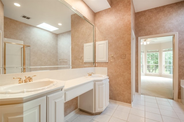 8635 Forest Glen Dr, Irving, TX 75063 - bathroom featuring double vanity, tile patterned floors, a tub, baseboards, and ceiling fan