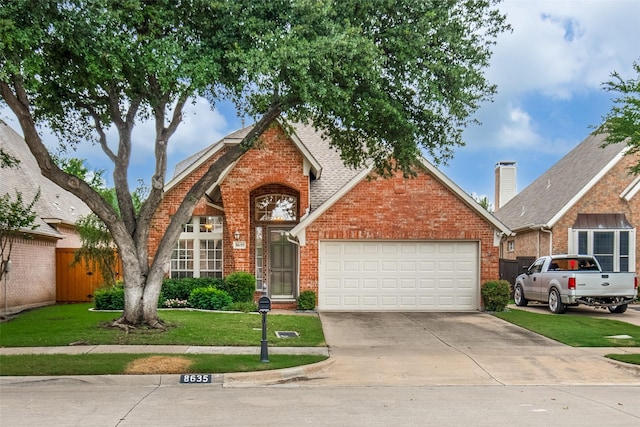 8635 Forest Glen Dr, Irving, TX 75063 - traditional home featuring brick siding, an attached garage, and driveway