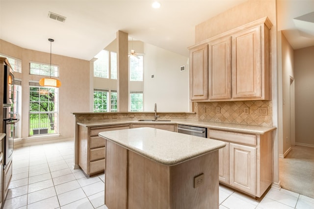 8635 Forest Glen Dr, Irving, TX 75063 - kitchen featuring light brown cabinetry, a sink, a center island, light tile patterned flooring, and a peninsula