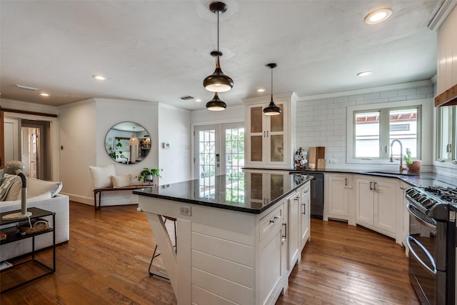 9923 Harwell Dr, Dallas, TX 75220 - kitchen featuring stainless steel appliances, a sink, ornamental molding, glass insert cabinets, and french doors