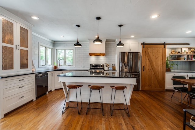 9923 Harwell Dr, Dallas, TX 75220 - kitchen with appliances with stainless steel finishes, a sink, a breakfast bar, dark countertops, and white cabinets